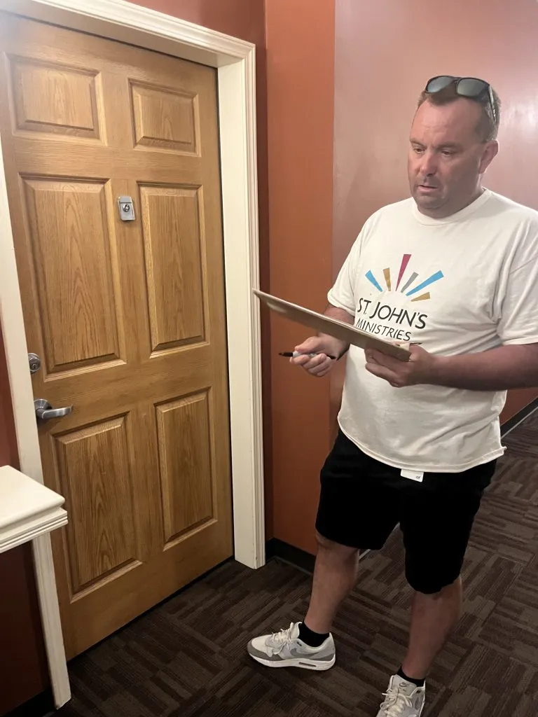 A volunteer holding a clipboard