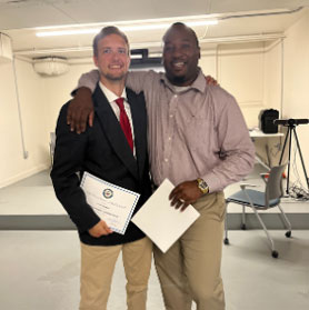 two men with their arms around each other