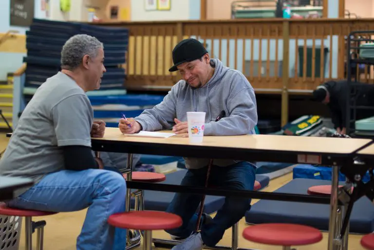 two men sitting at a table
