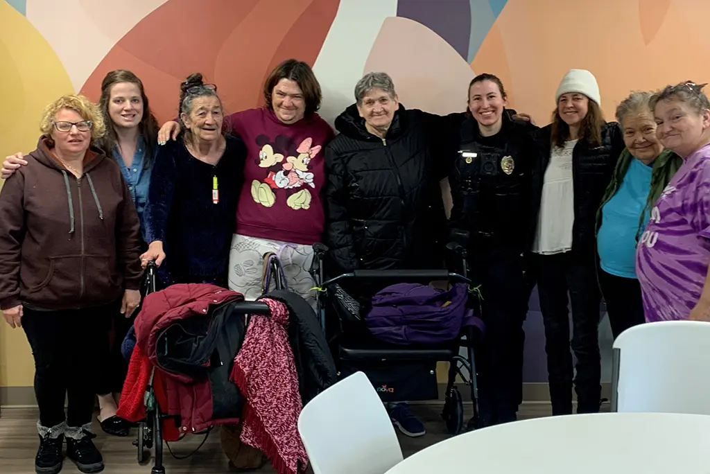 A Green Bay police department female officer with ladies from Wellspring